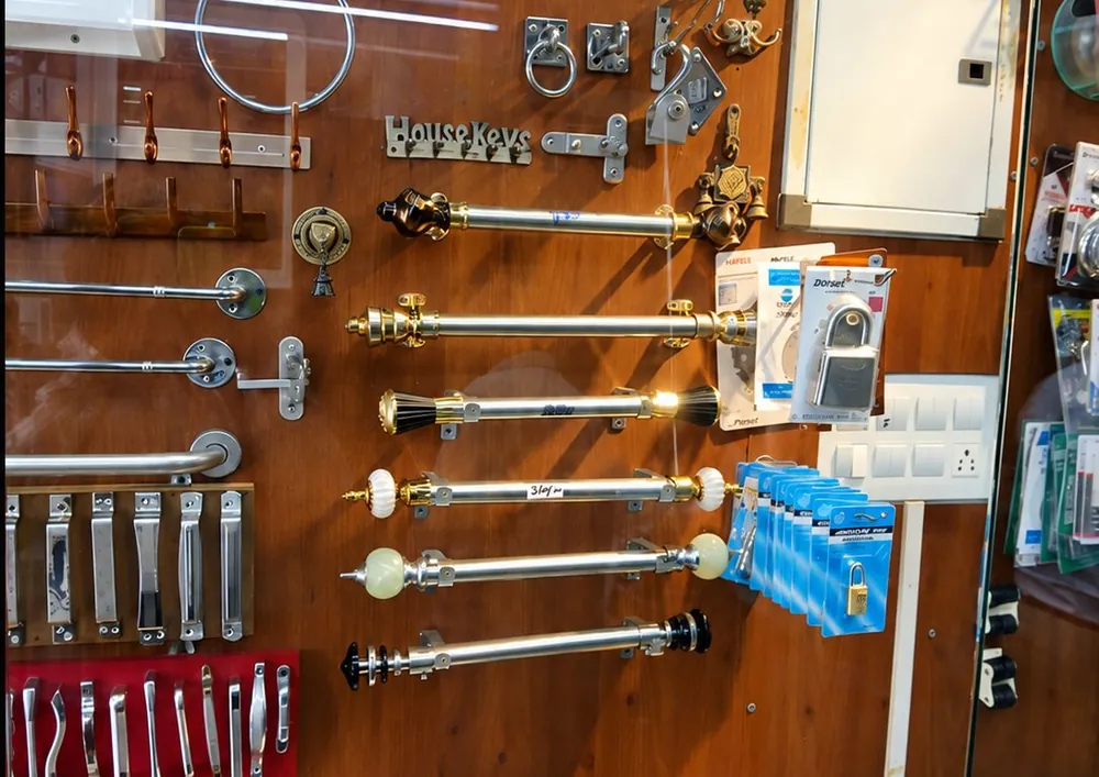Display wall at Chennai Traders with curtain rods, handles, hooks and other hardware